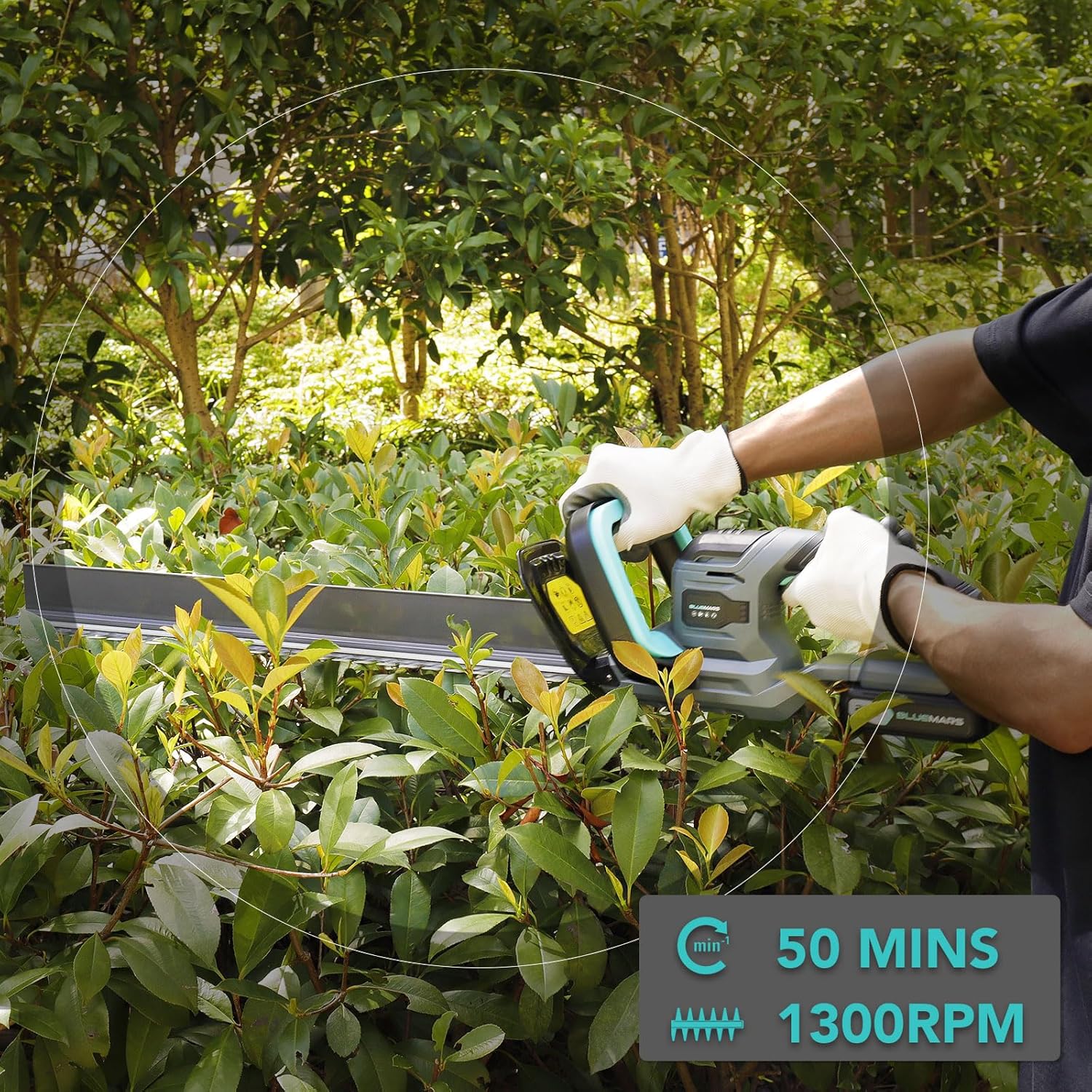 Person using a hedge trimmer in a garden with a focus on battery life and performance.