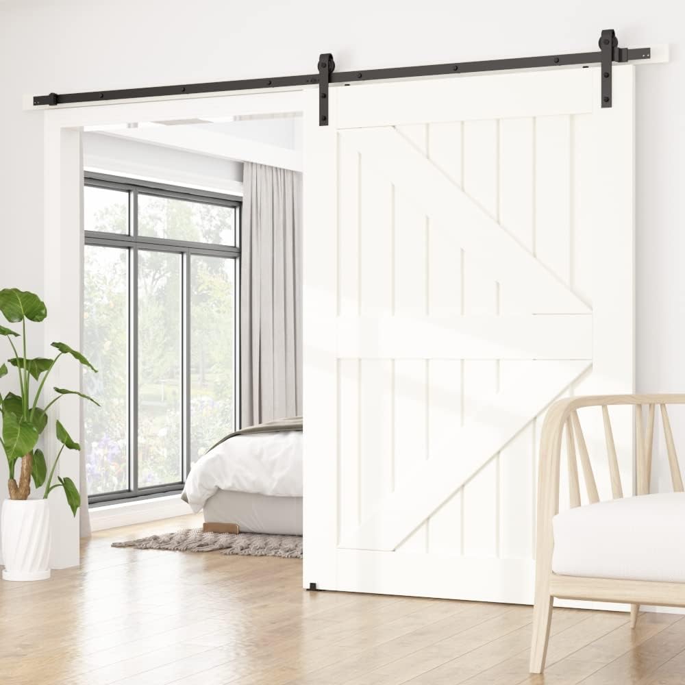 Barn door with black track in a modern bedroom setting