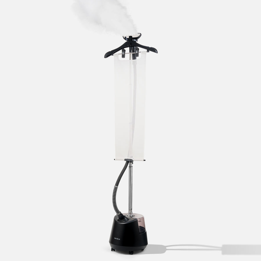 Black garment steamer with a white lampshade on a white background
