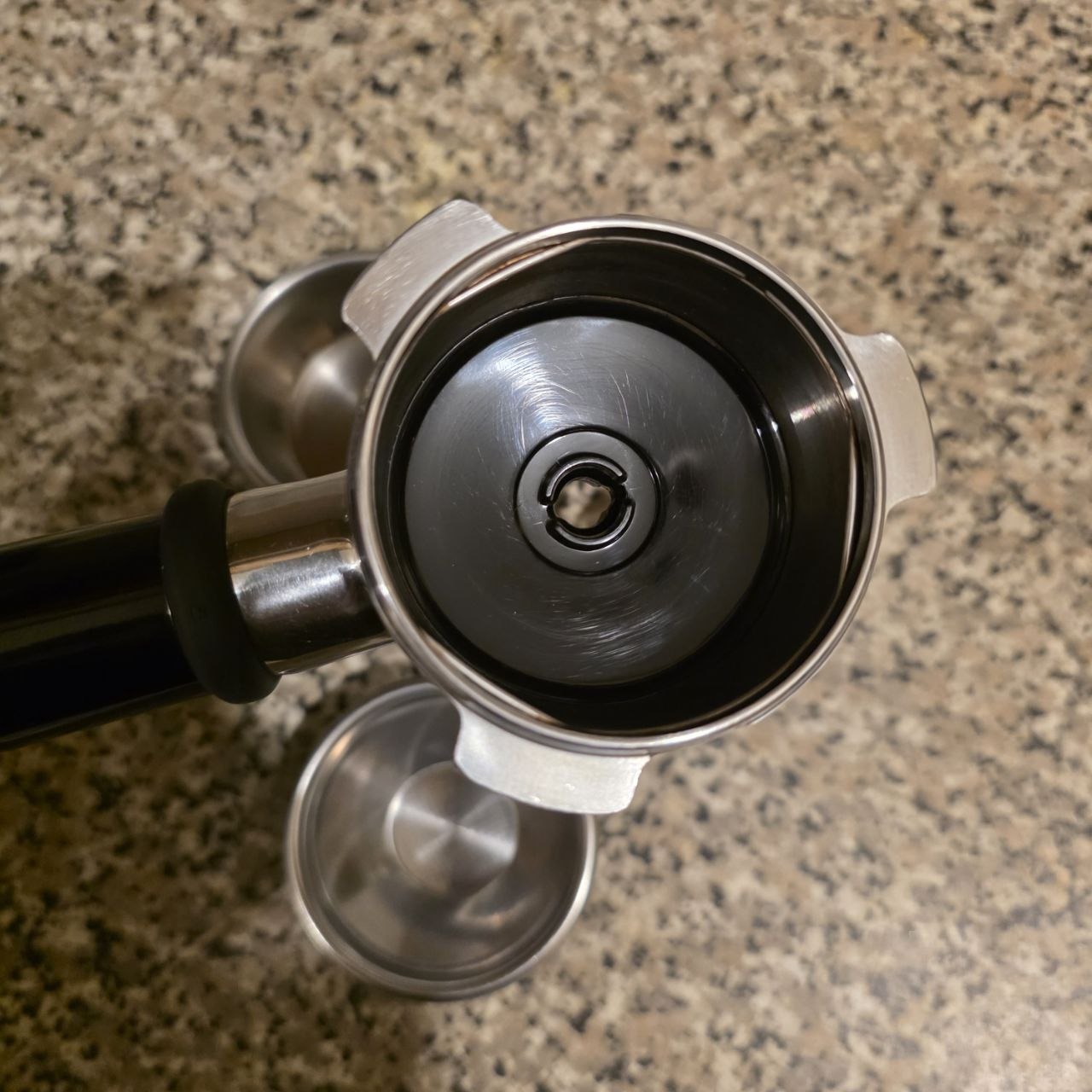 Metal grinder on a speckled countertop