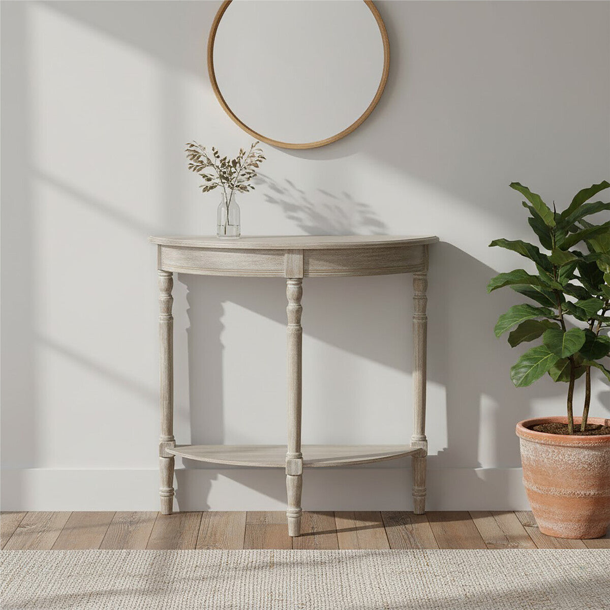 Corner console table with a plant and mirror in a room with wooden flooring and white walls.