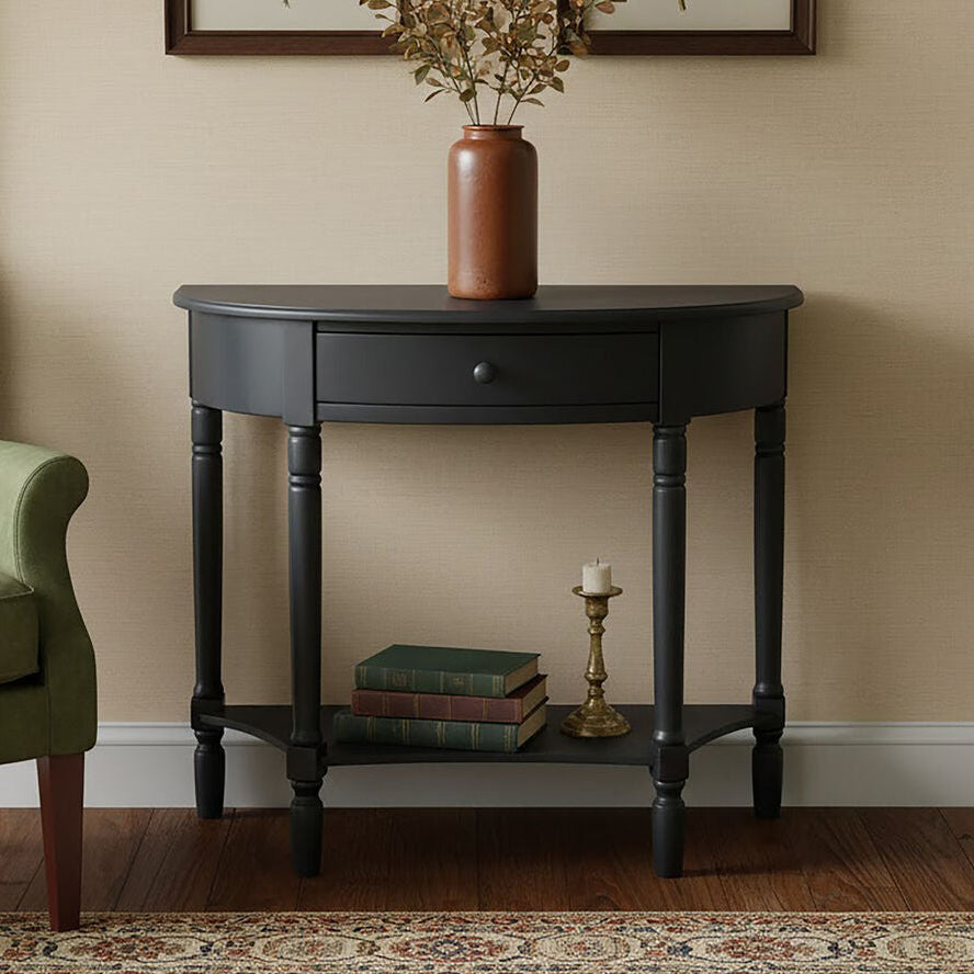 Black console table with a vase, books, and candlestick in a room setting.