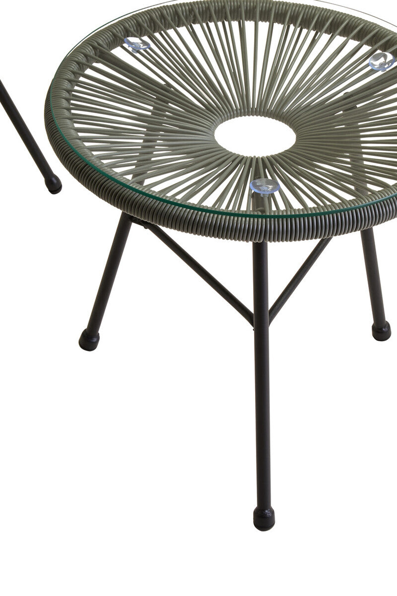 Round glass table with wicker-like top and metal legs on a white background