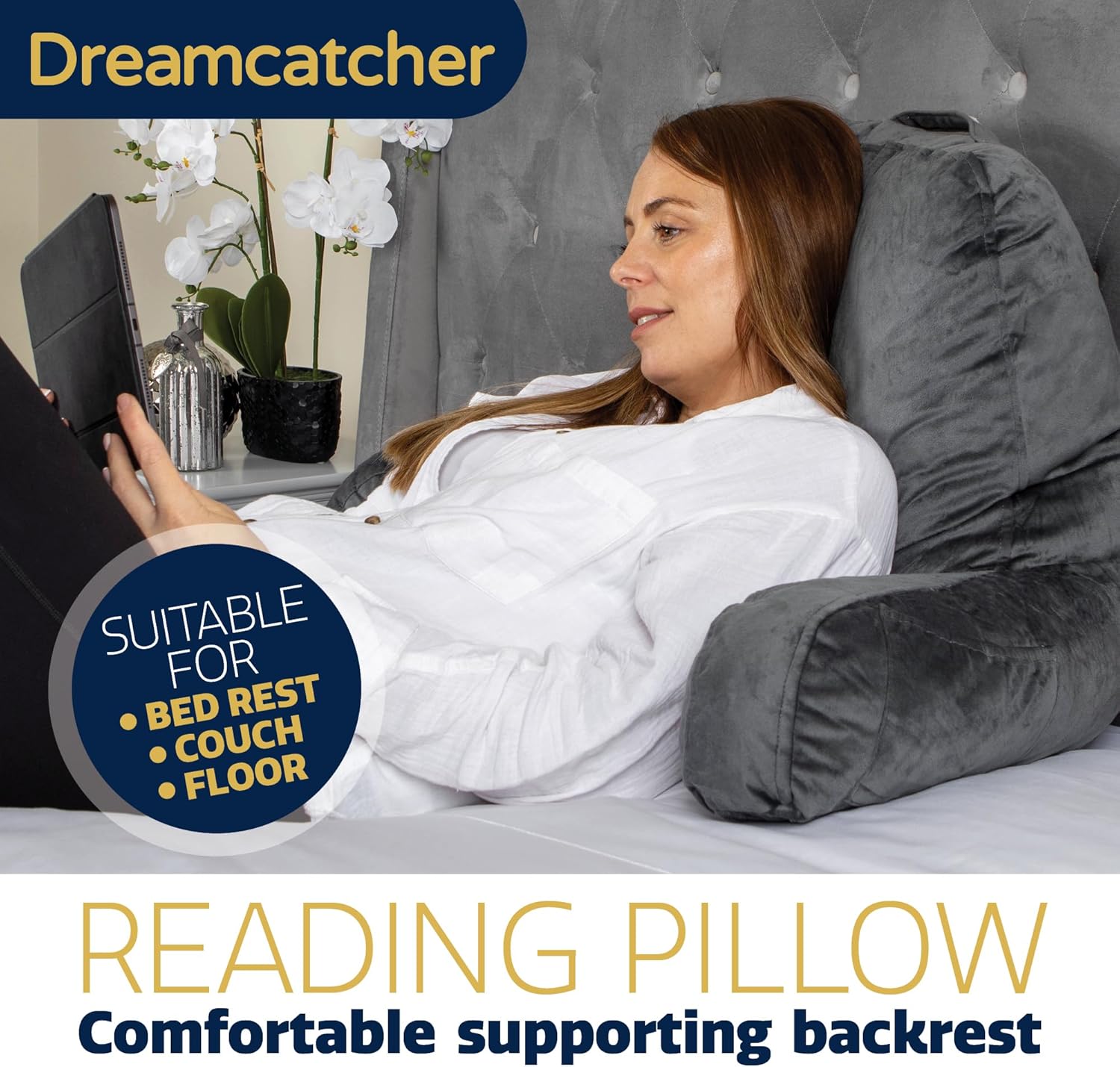 Woman using a reading pillow in a living room setting with Dreamcatcher branding.