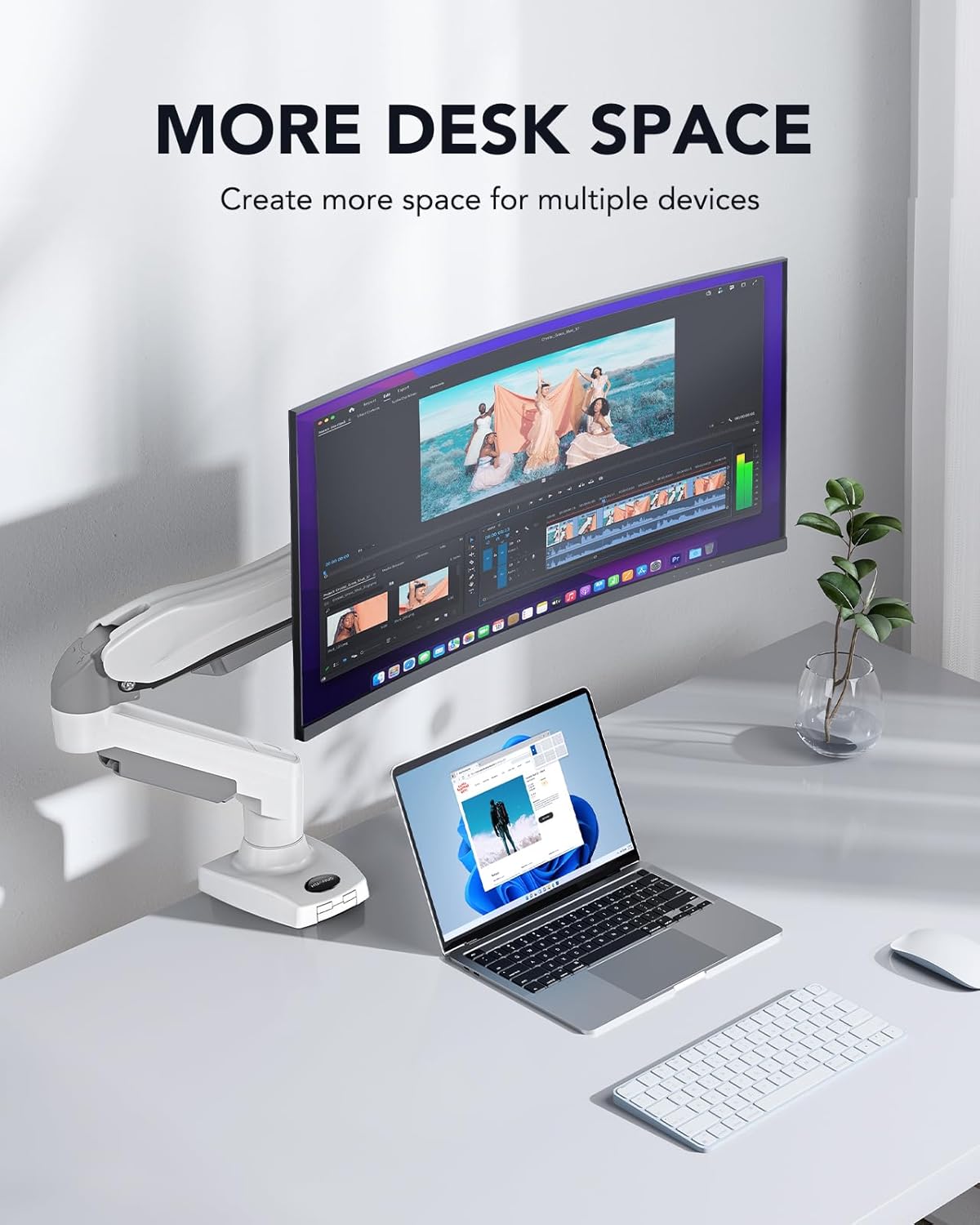 Desk setup with a monitor and laptop on a white surface, featuring text 'More Desk Space'.