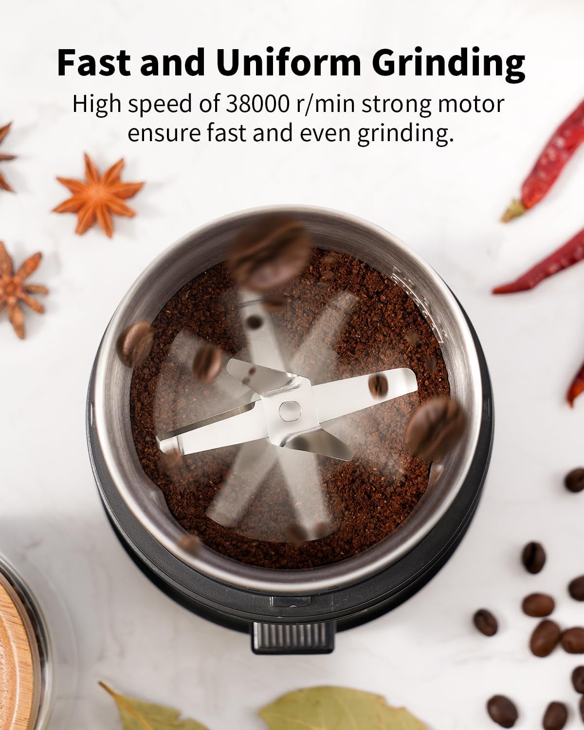 Coffee grinder with ground coffee and coffee beans on a white background