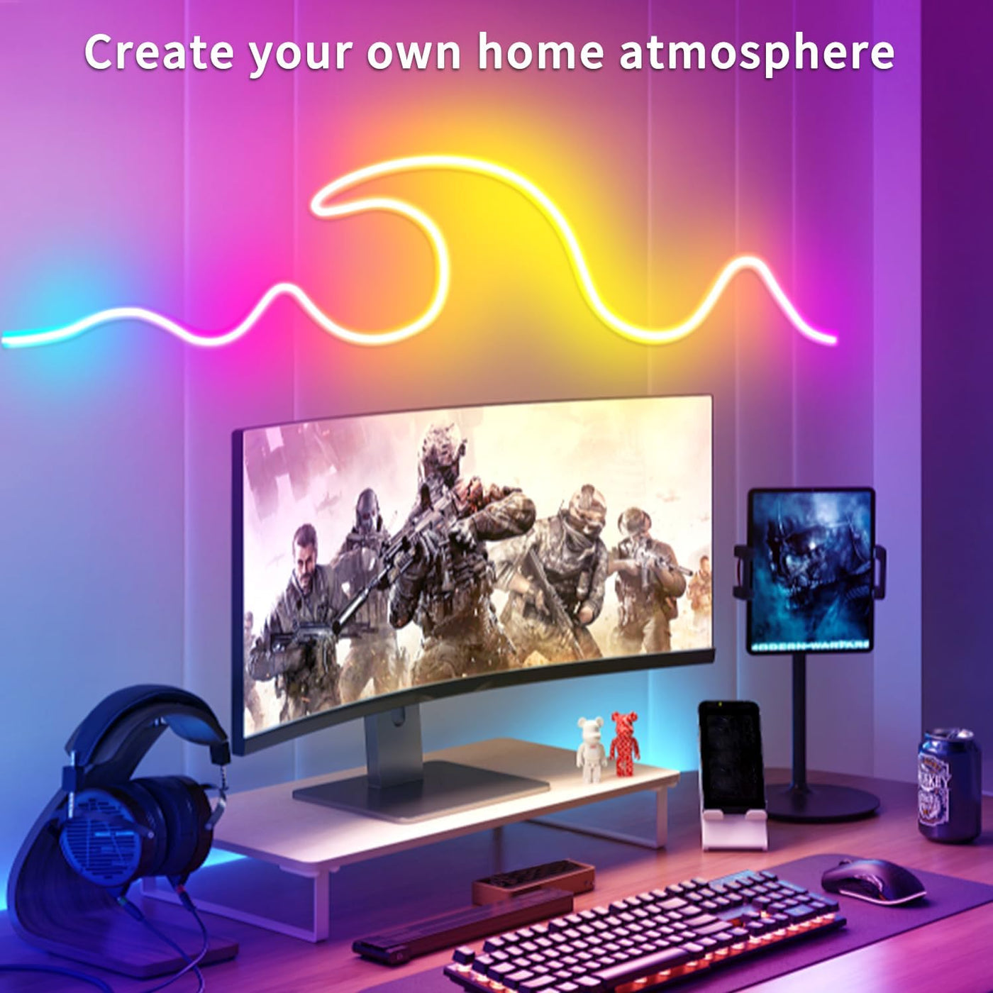 Gaming setup with monitor, keyboard, mouse, and colorful LED lights on a purple wall.