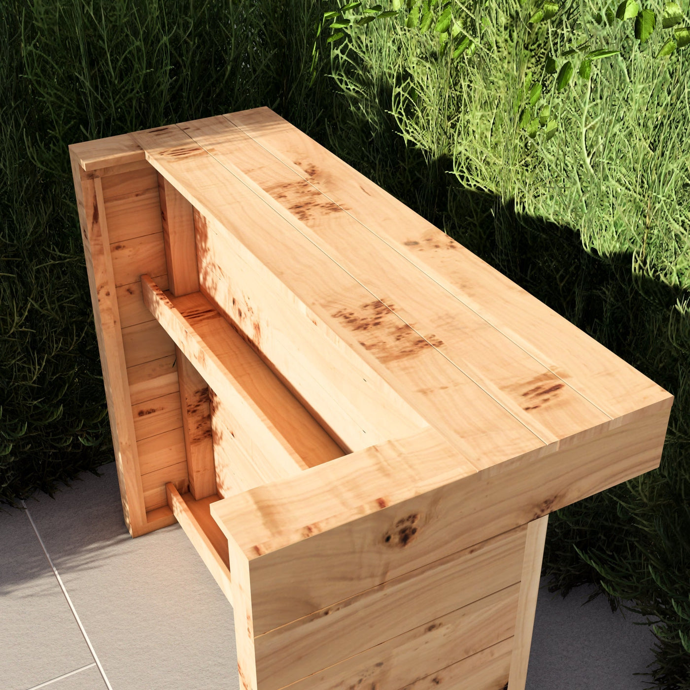 Wooden outdoor bench with storage compartments against a green bush background