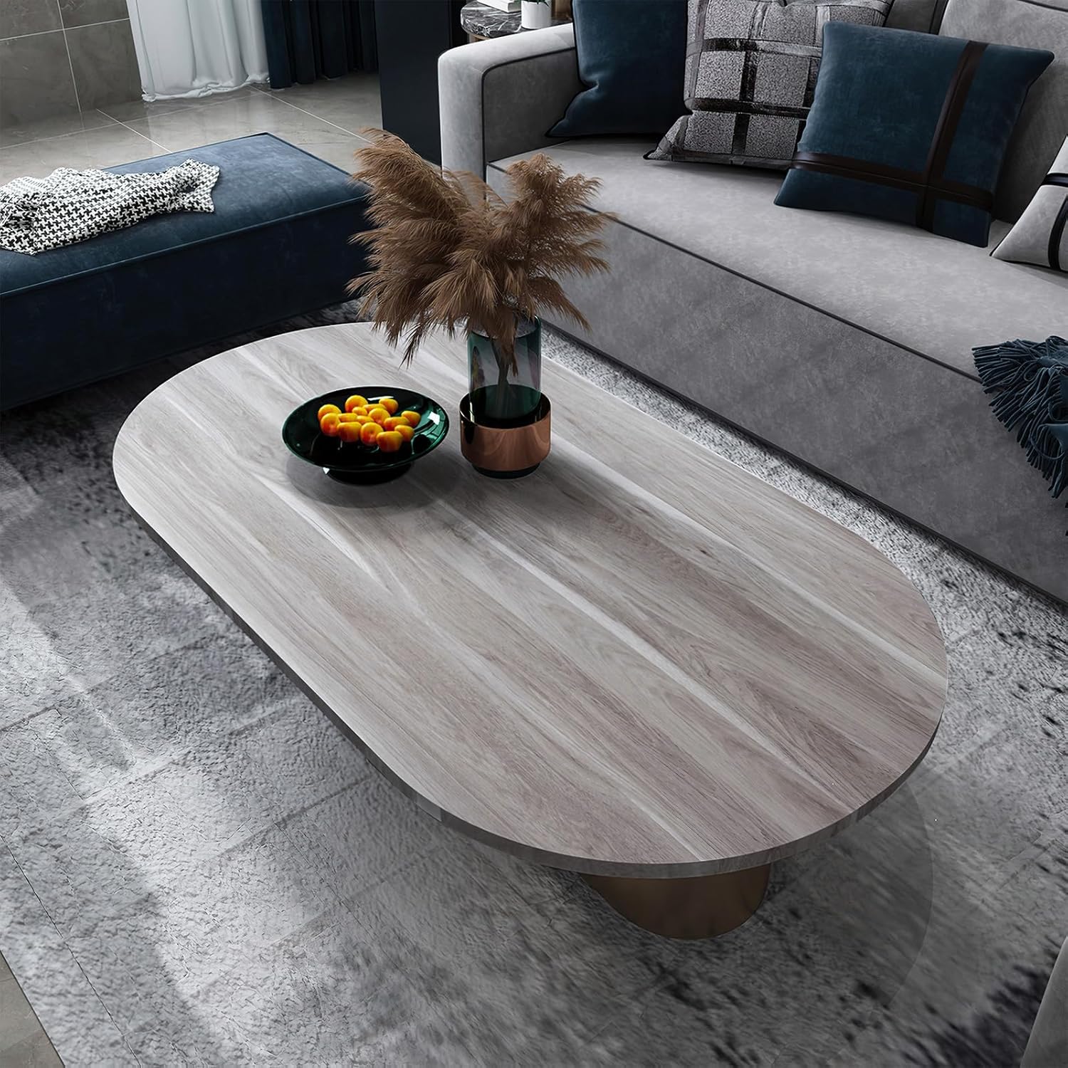 Oval coffee table with decorative items in a living room setting