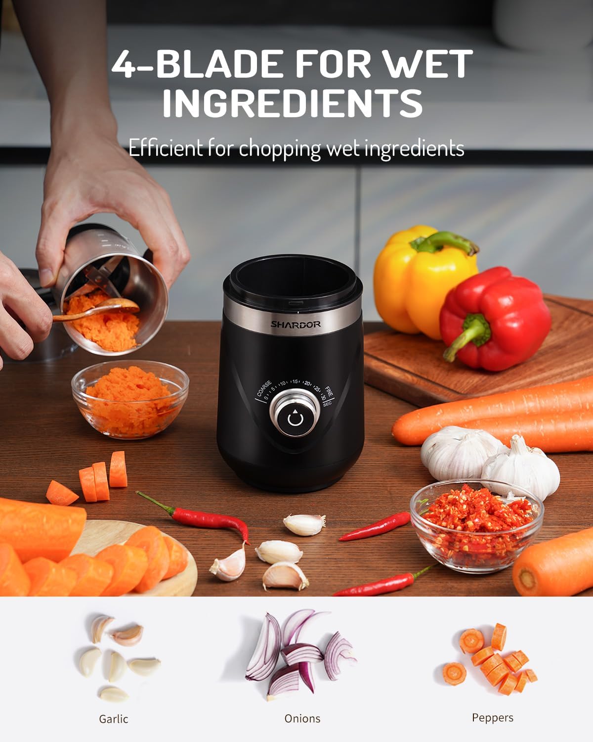Black handheld food chopper with chopped vegetables on a wooden surface, highlighting its use for wet ingredients.