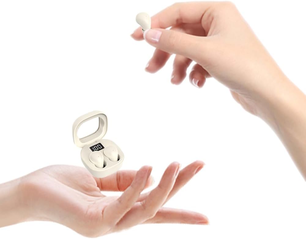 Small white electronic device held in a hand with a clear background