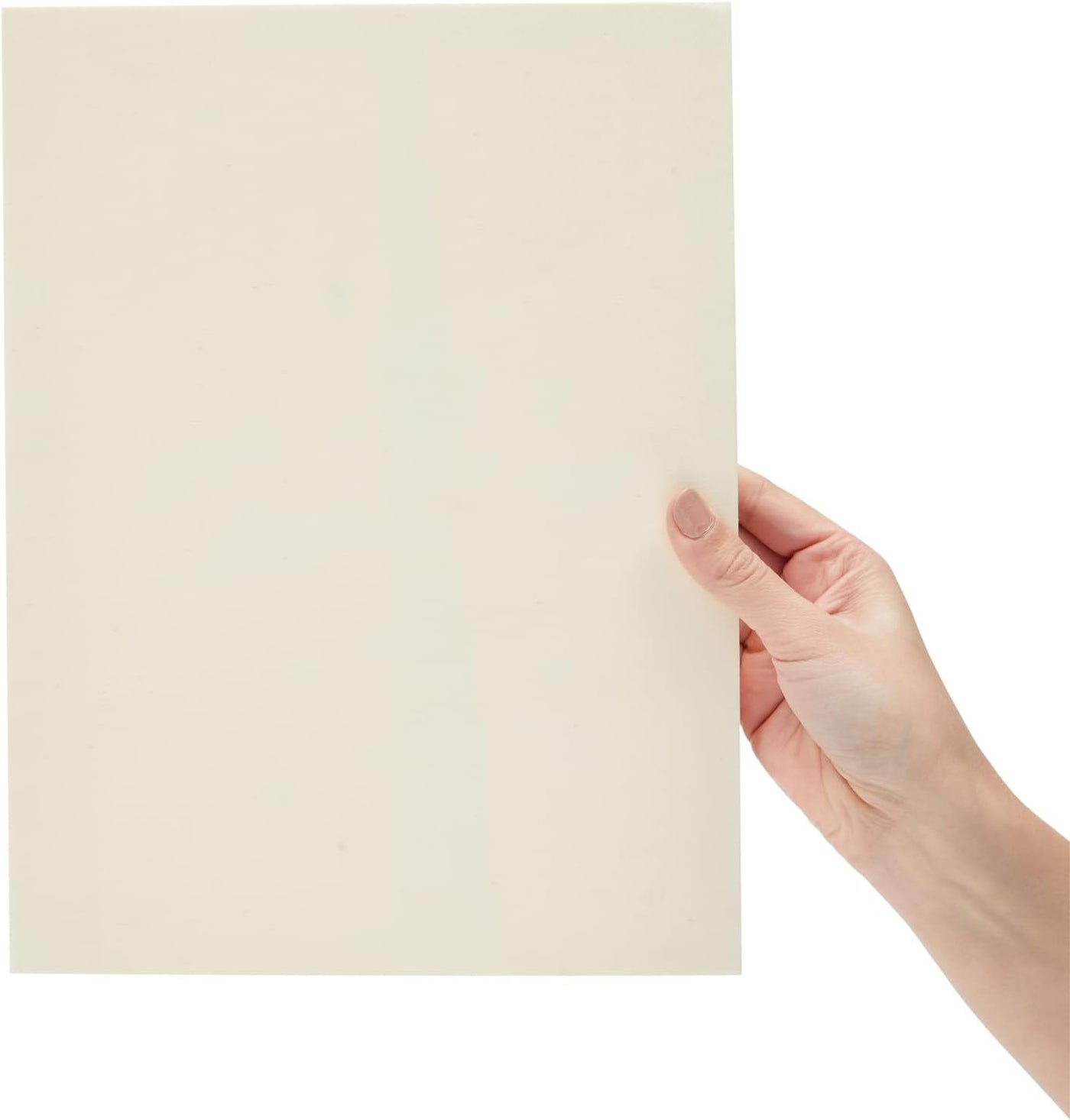 Hand holding a beige color swatch against a white background