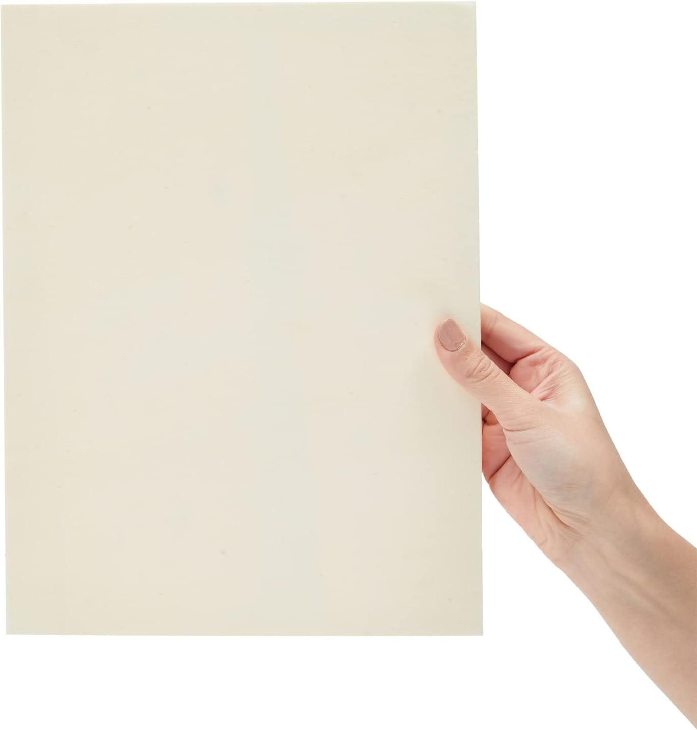Hand holding a beige color swatch against a white background