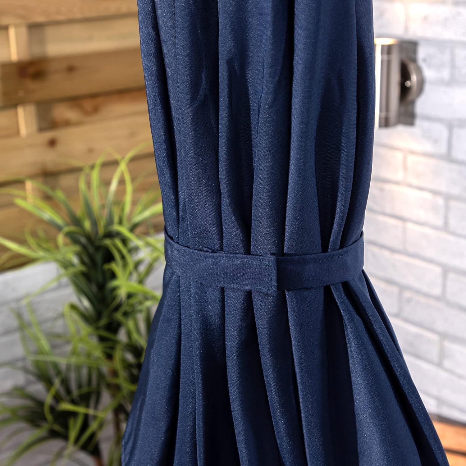 Navy blue curtain with a belt against a blurred outdoor background