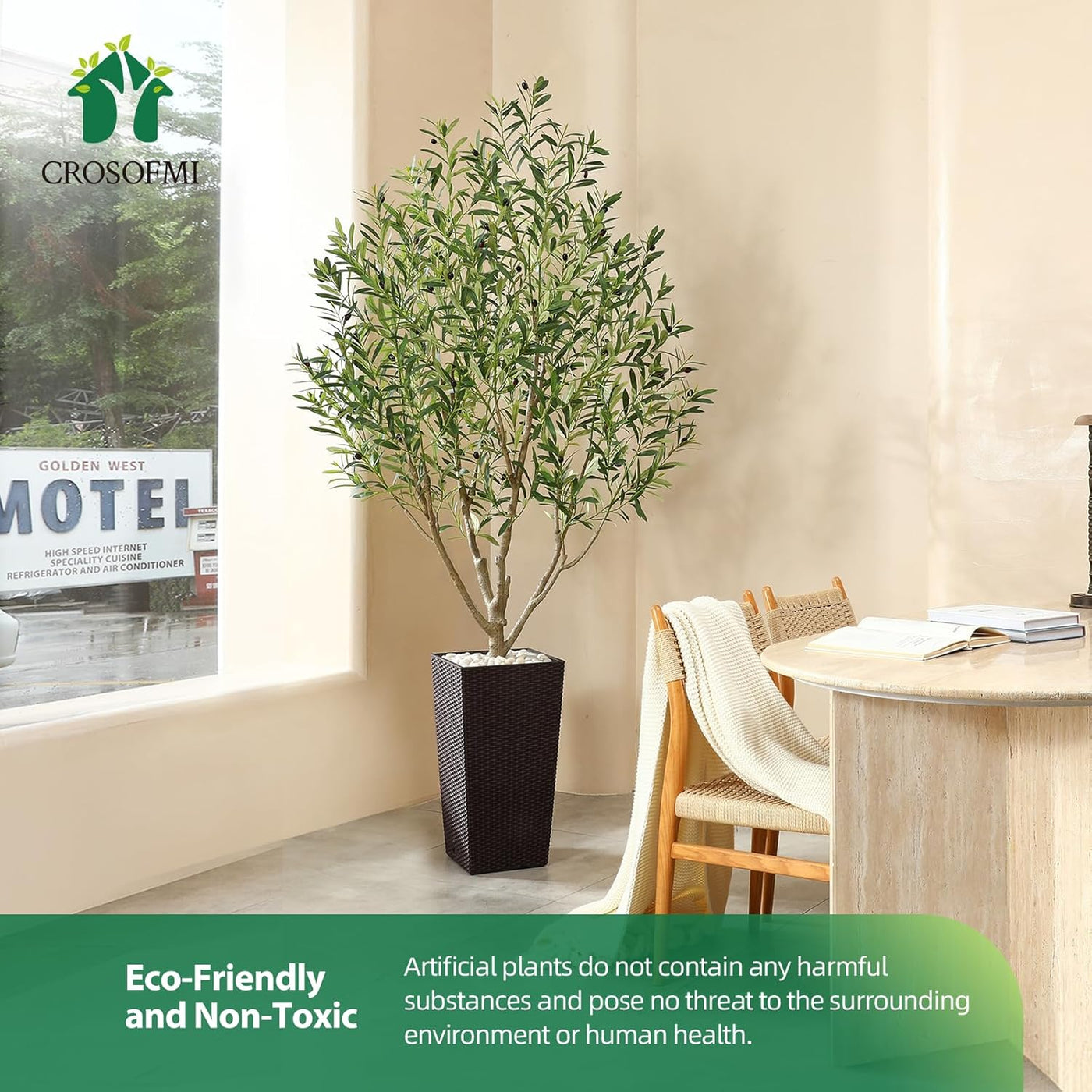 Artificial plant in a pot on a table with a window and motel sign in the background, featuring Crosoemi branding.