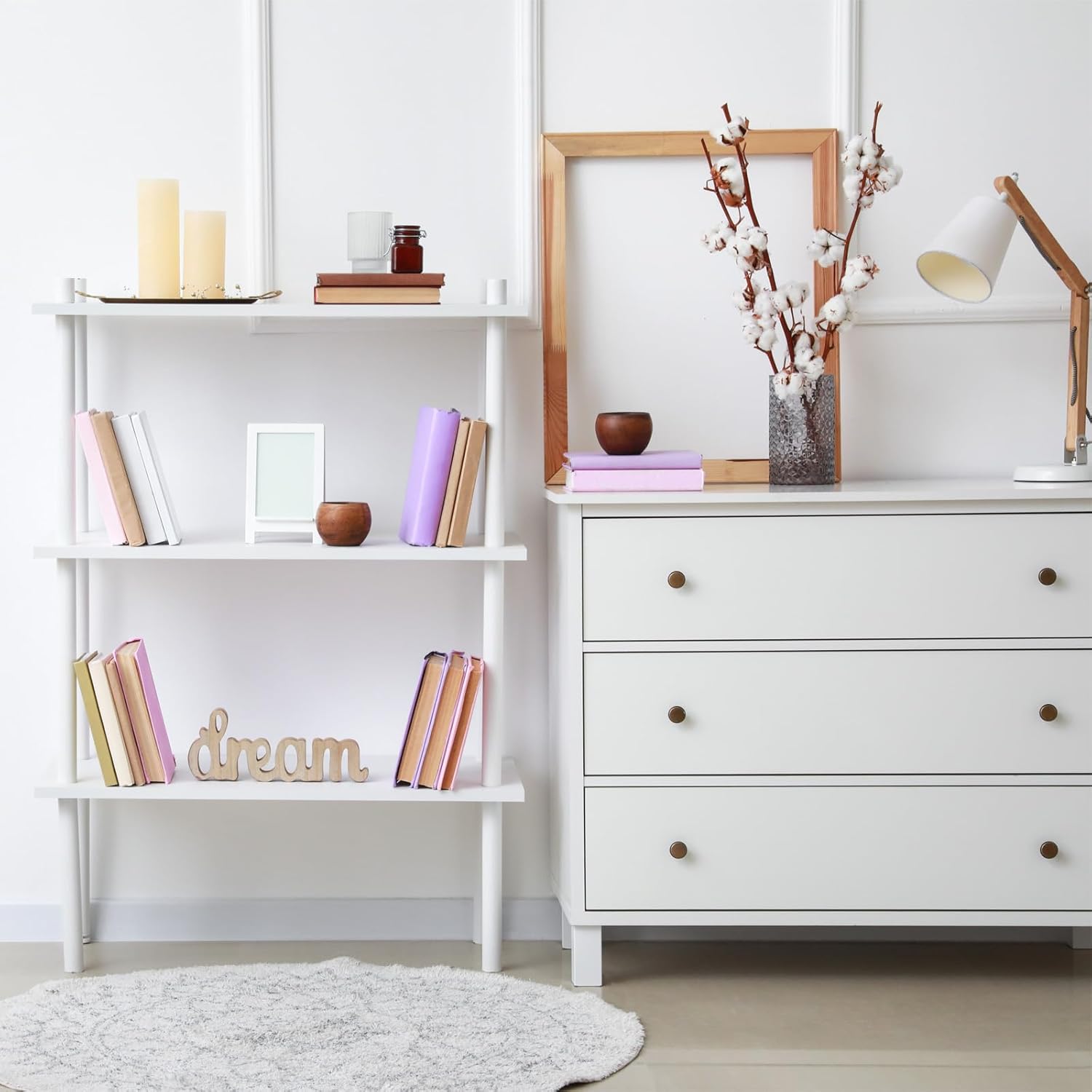 White dresser and bookshelf with decorative items in a room.