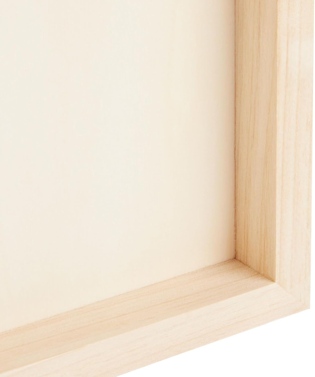 Close-up of a wooden frame corner on a light beige background