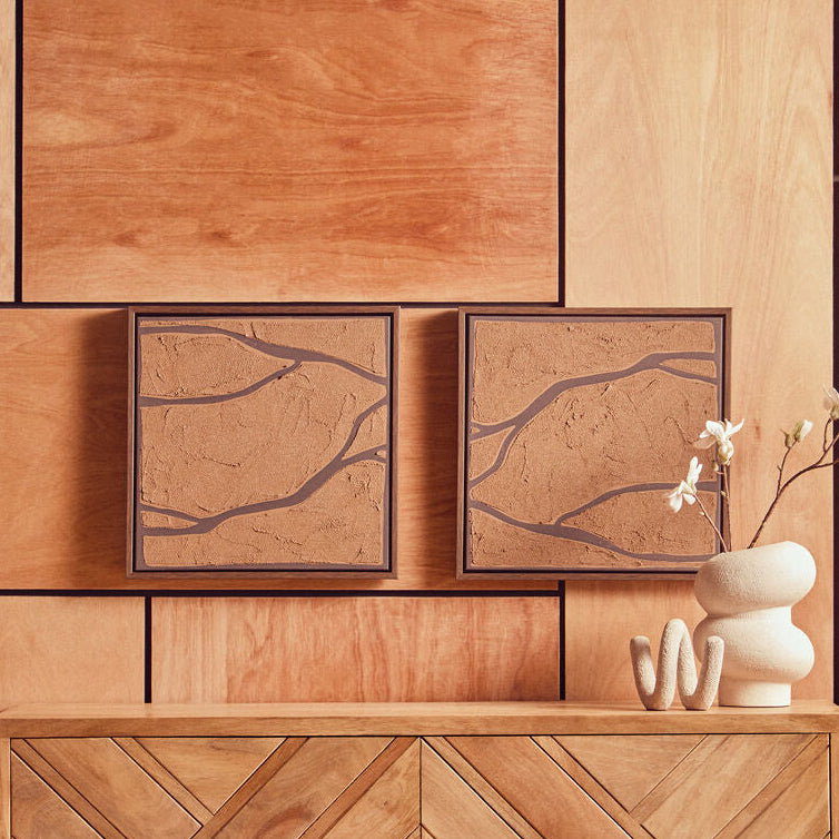 Wooden wall panels with abstract art and decorative items on a wooden surface.