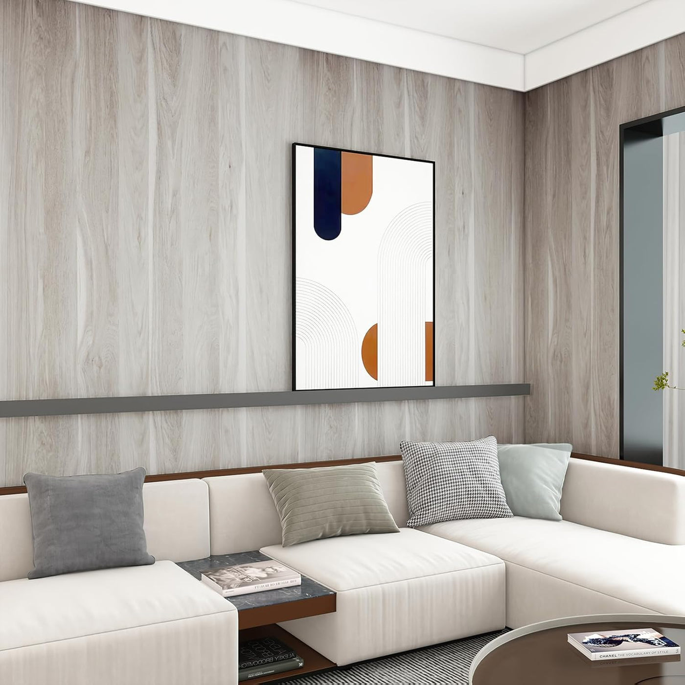 Modern living room with a white sectional sofa, abstract art on the wall, and a coffee table.