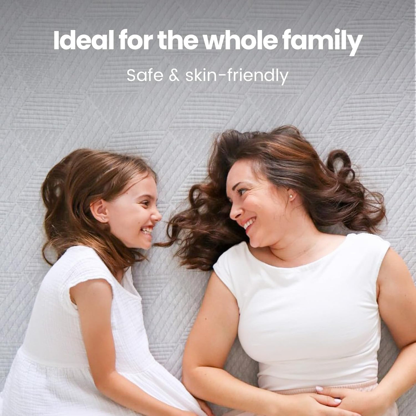 Woman and young girl lying on a textured surface with text 'Ideal for the whole family, Safe & skin-friendly'.