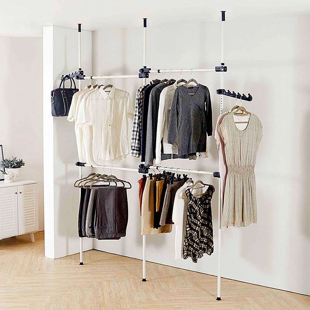 Clothing rack with various garments against a white wall