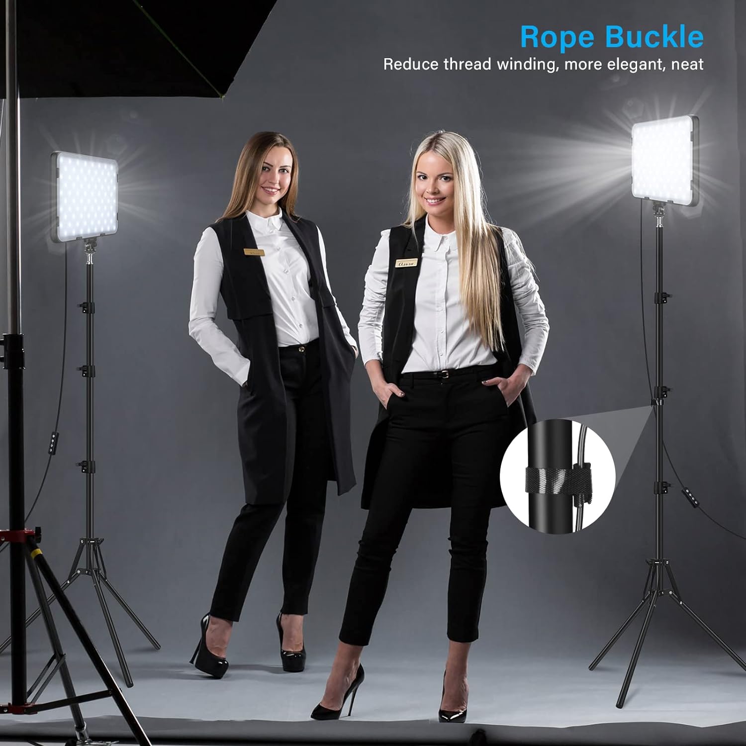 Two women in professional attire standing in a photo studio with lighting equipment.
