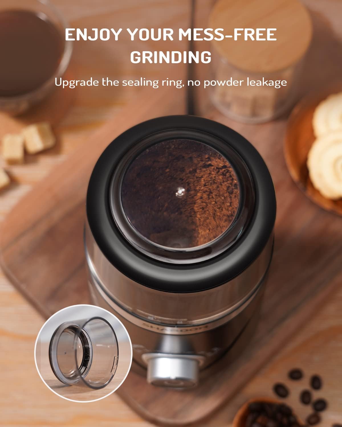 Coffee grinder with mess-free grinding feature on a wooden surface with coffee beans and a sealing ring detail.