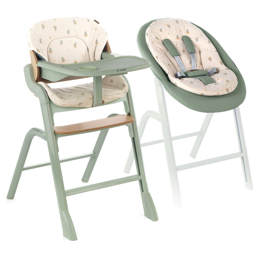 Green high chair and baby seat with floral pattern on a white background
