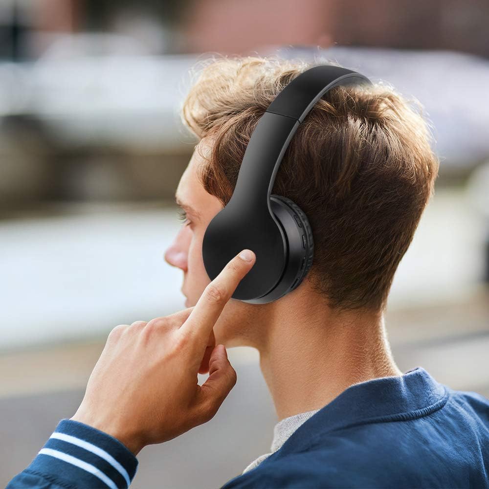 Person wearing black headphones with a blurred background