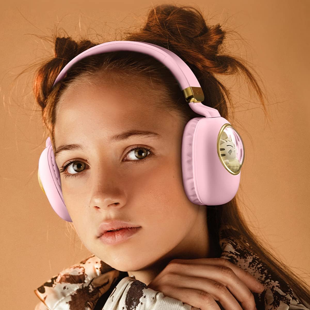 Young girl wearing pink headphones with a decorative emblem on a beige background