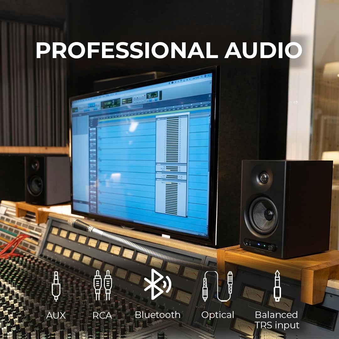 Professional audio setup with monitor, speakers, and mixing console in a studio.