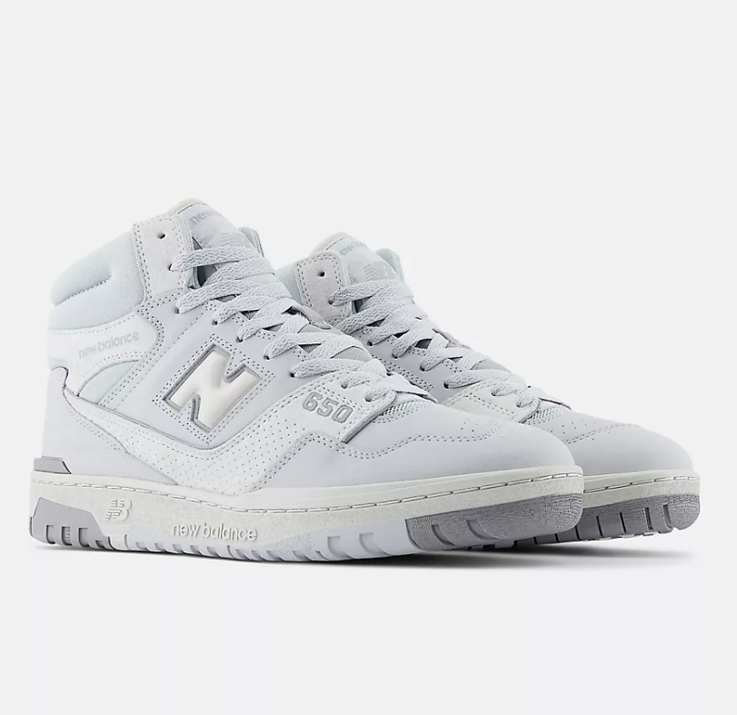 White high-top sneakers with New Balance logo on a light gray background