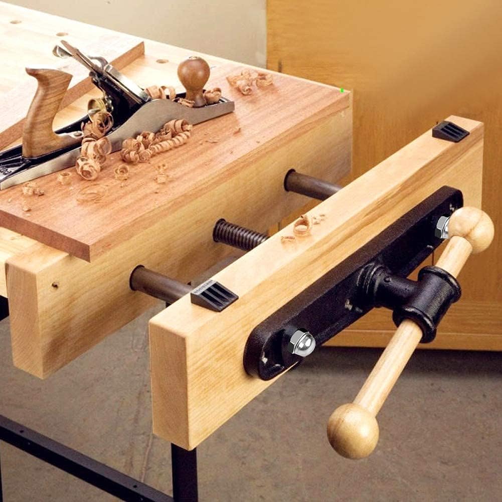 Wooden workbench with clamps and woodworking tools on a wooden surface.