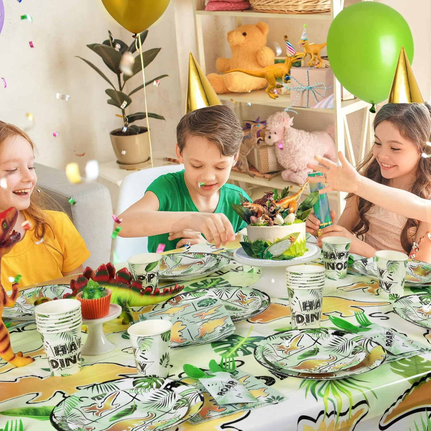 Children enjoying a meal at a dinosaur-themed birthday party with colorful decorations and tableware.