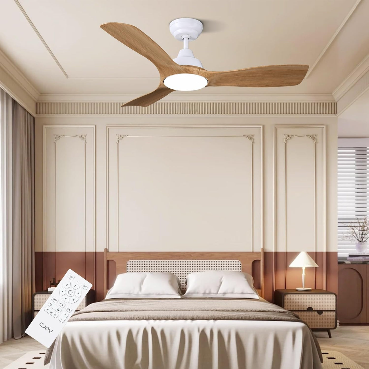 Ceiling fan in a bedroom with a bed and lamp in the background