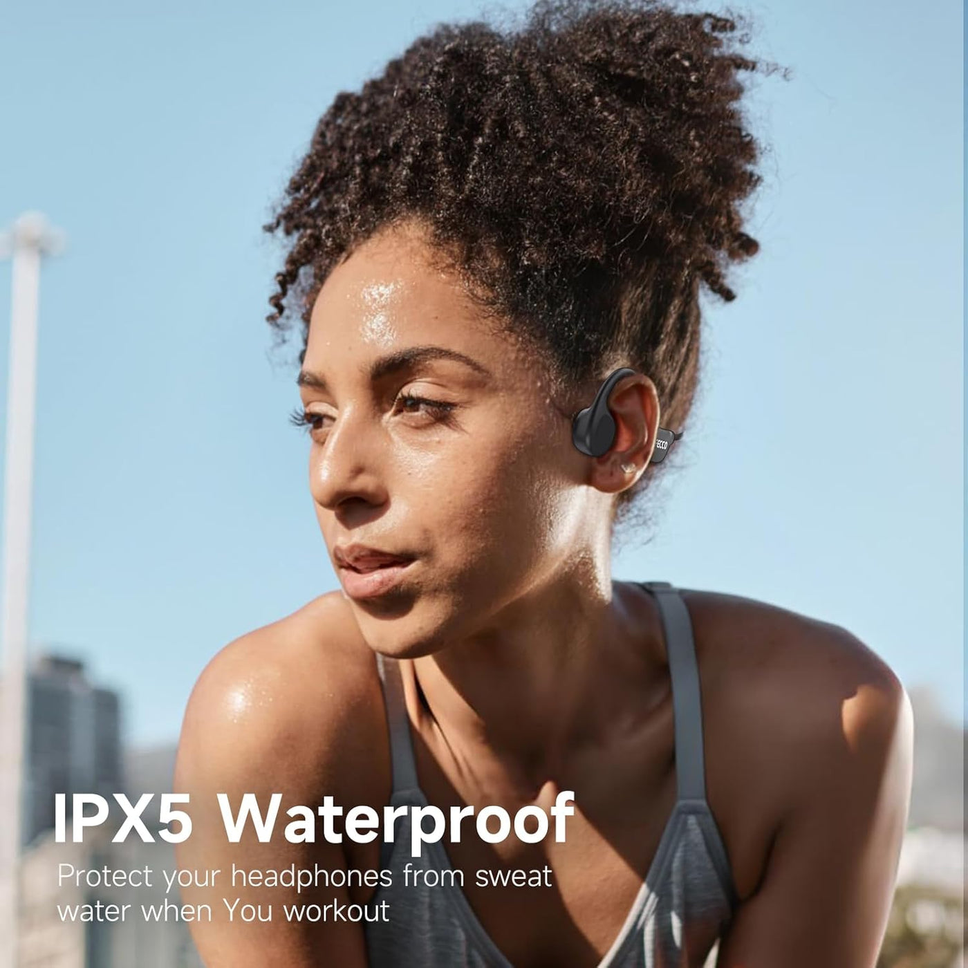 Woman wearing wireless earbuds with text about IPX5 waterproof feature.