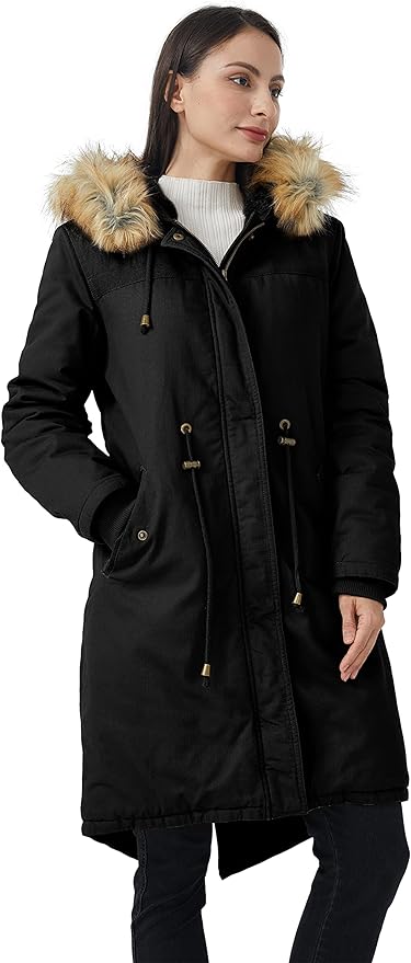 Woman wearing a black coat with fur-lined hood on a white background