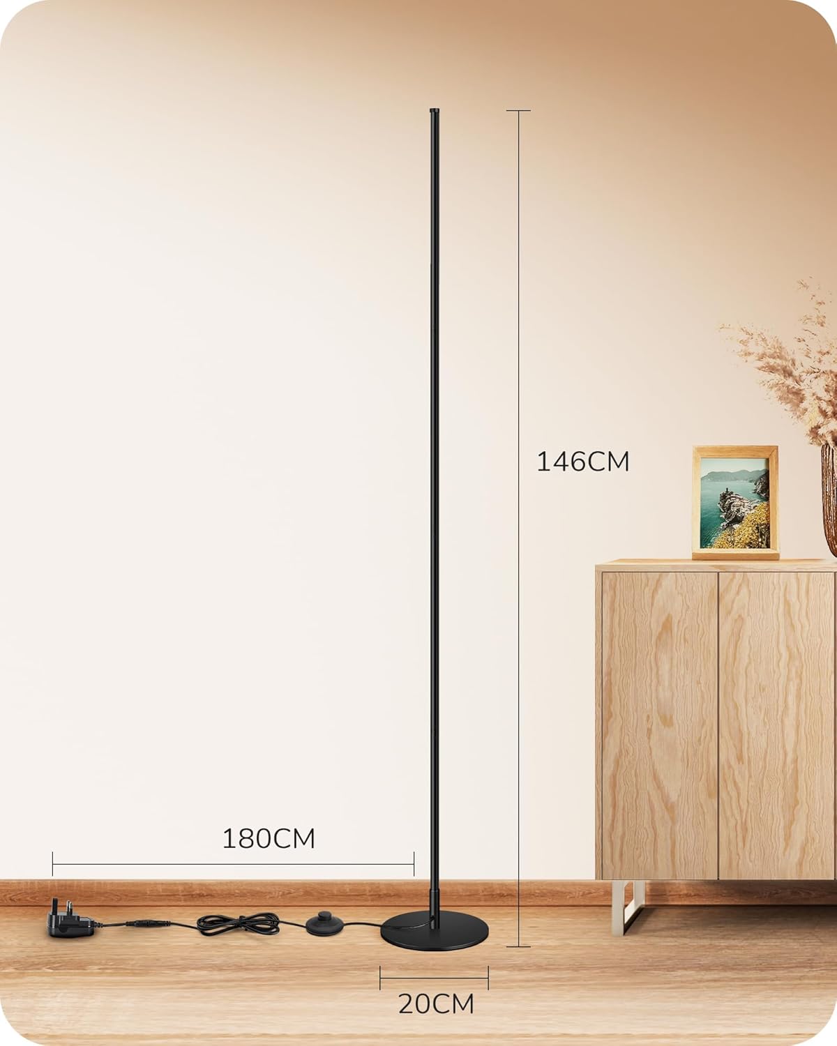 Black floor lamp with measurements on a wooden floor and cabinet background