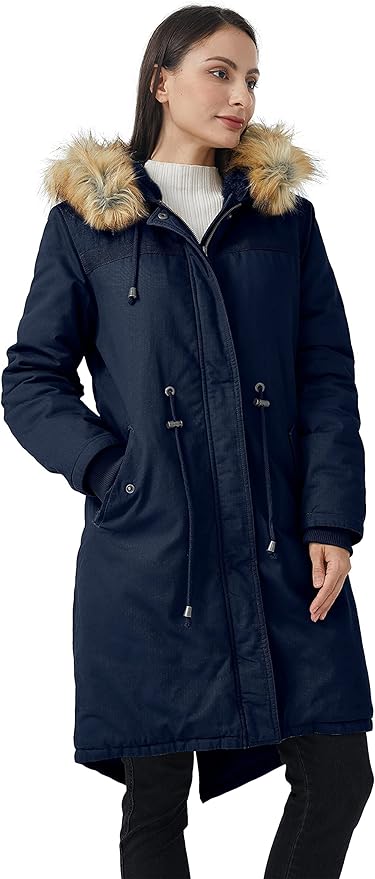 Woman wearing a navy parka with fur-lined hood on a white background