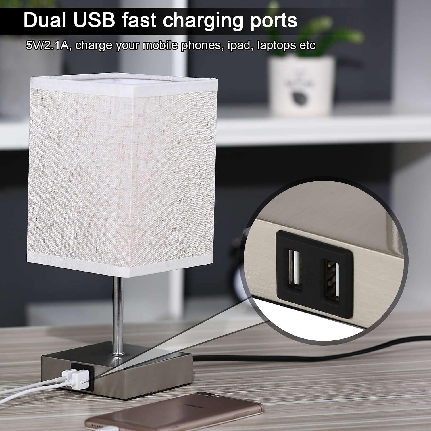 Table lamp with dual USB charging ports on a desk, showing close-up of ports.