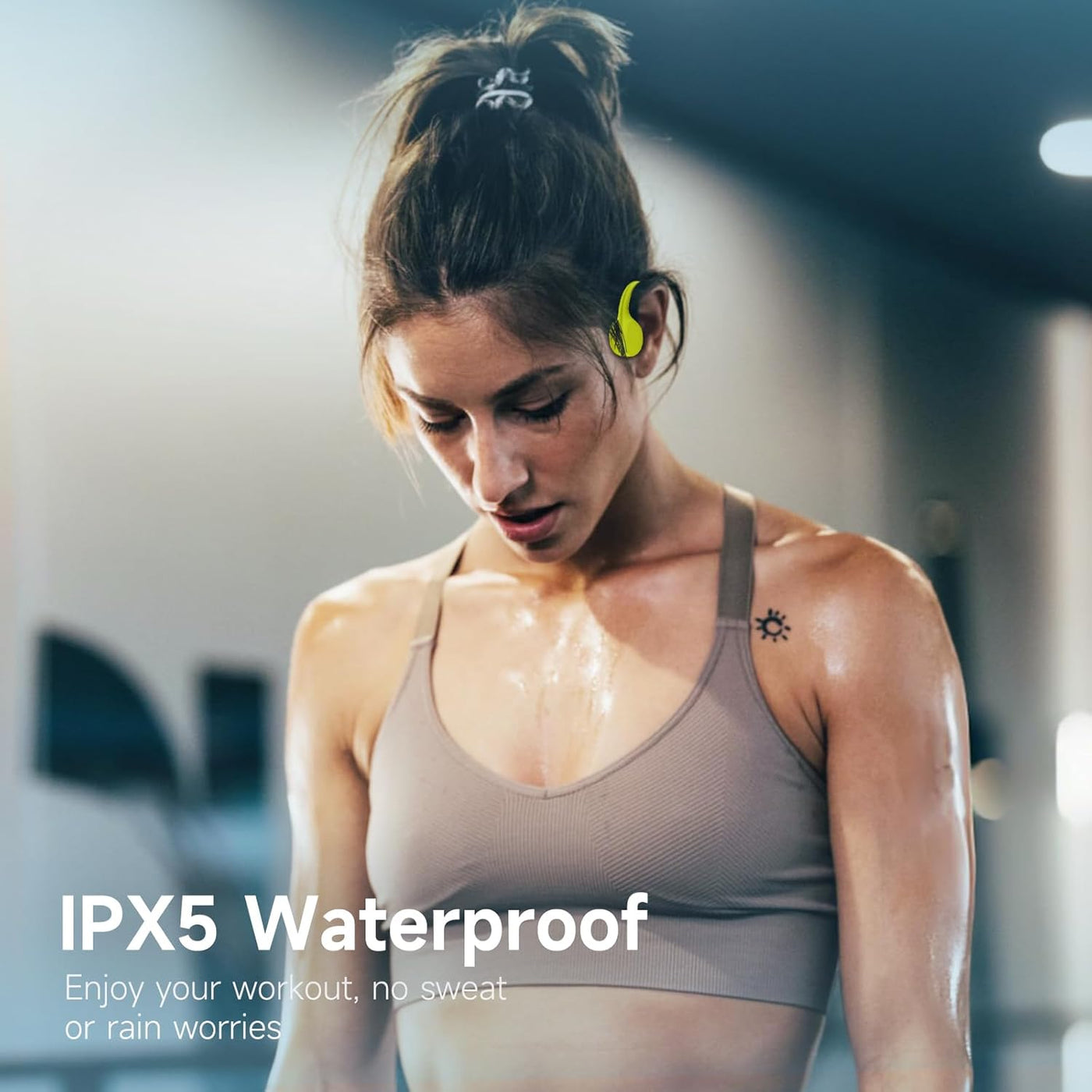 Woman exercising with wireless earbuds, emphasizing IPX5 waterproof feature.