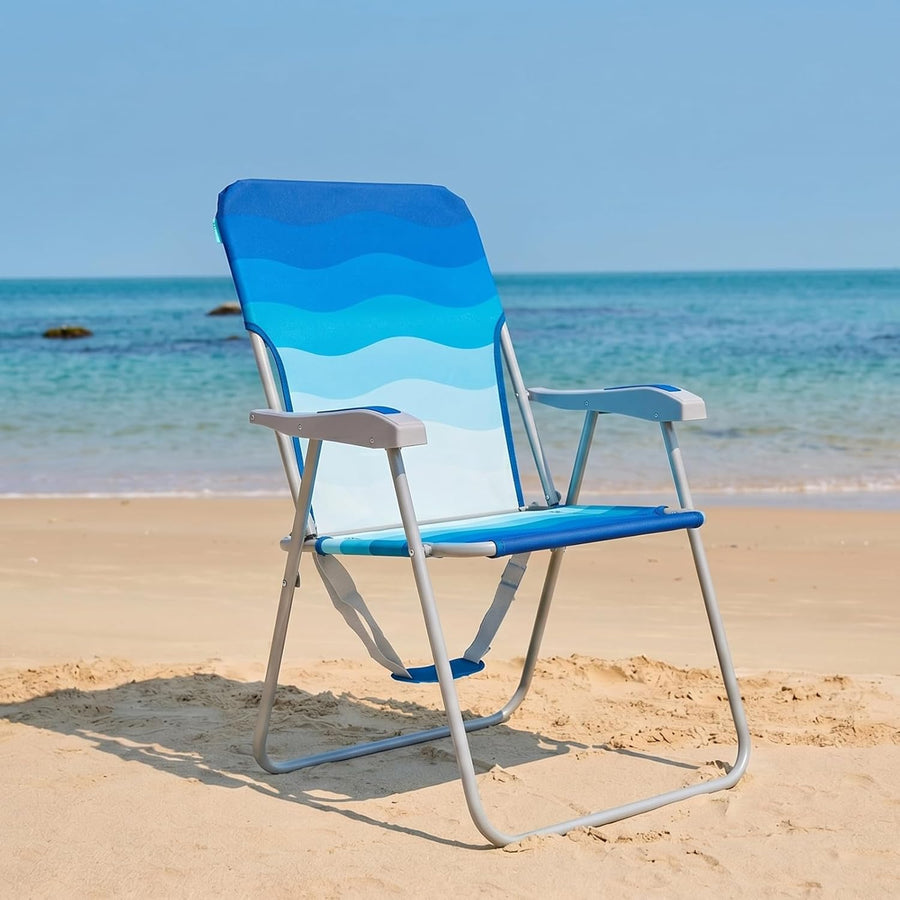Blue and white beach chair on a sandy beach with ocean in the background