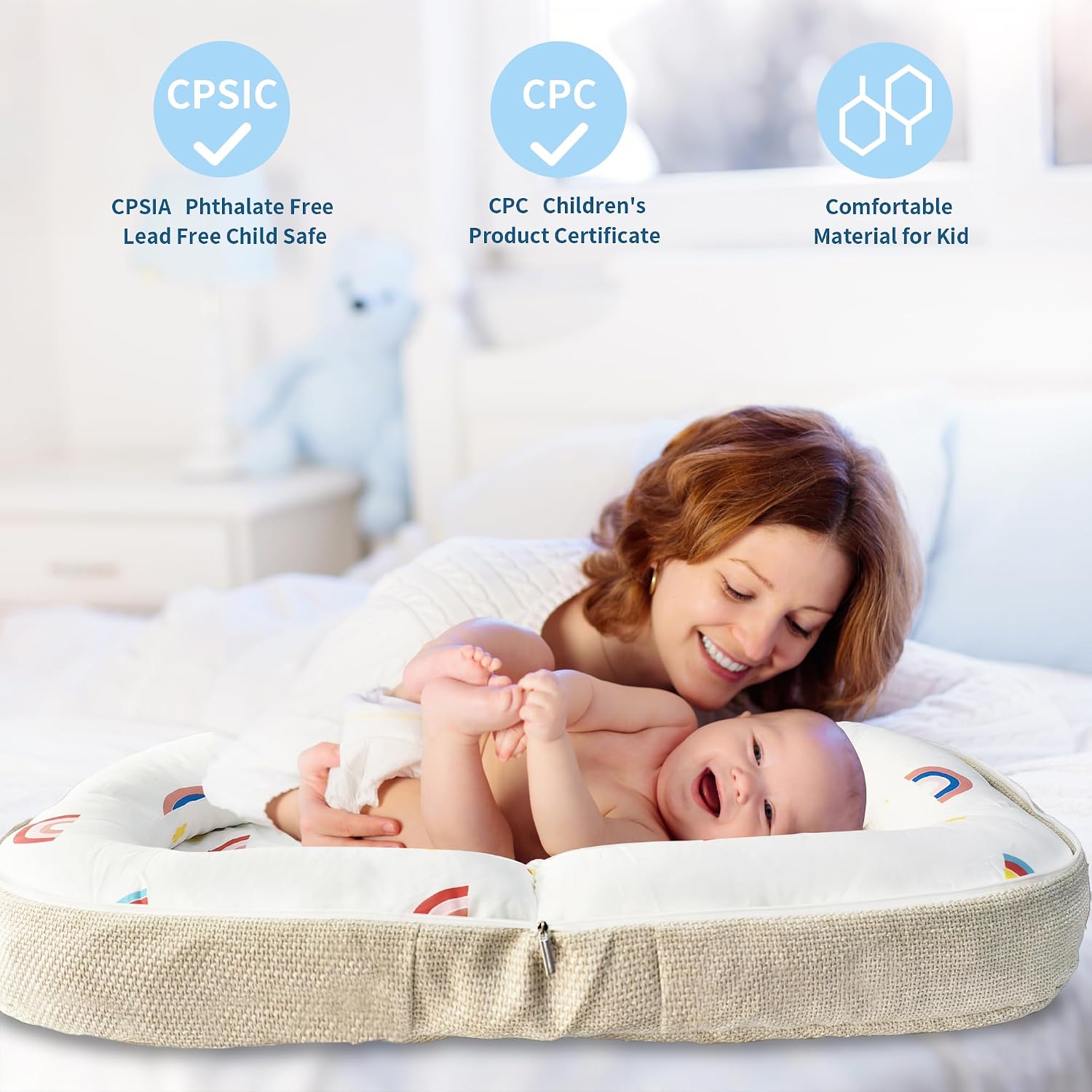 Woman holding a baby on a cushion with certification logos displayed.