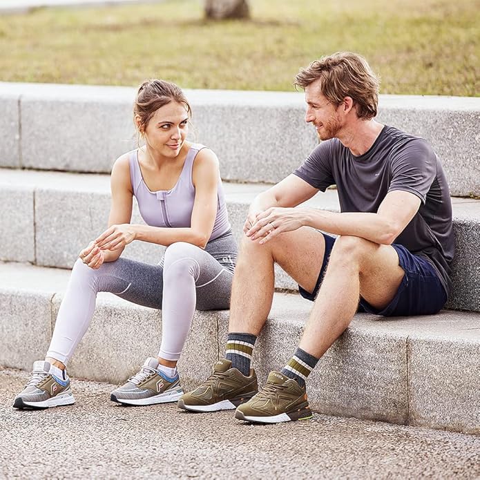 Two people sitting on stone steps outdoors, possibly after a workout.