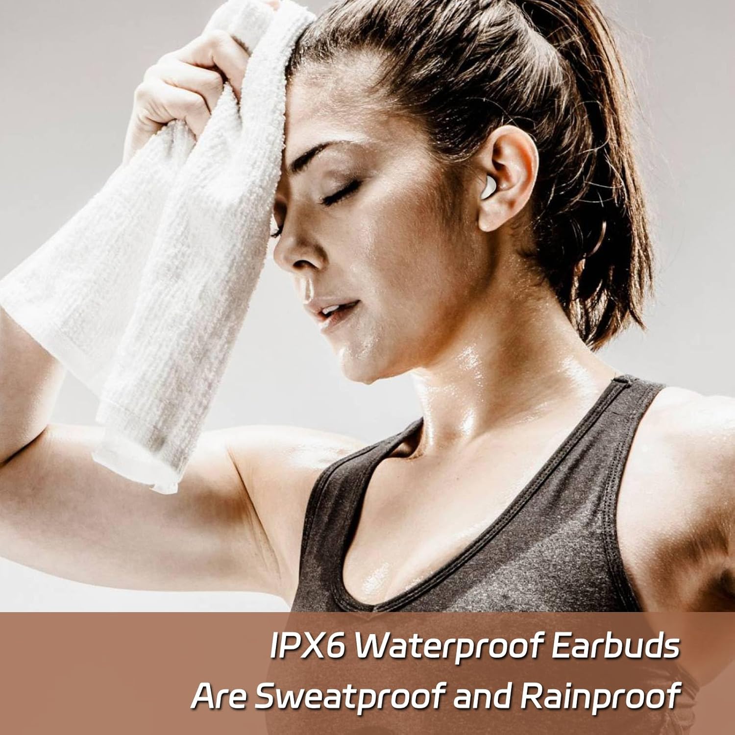 Woman exercising with a towel, wearing IPX6 waterproof earbuds.