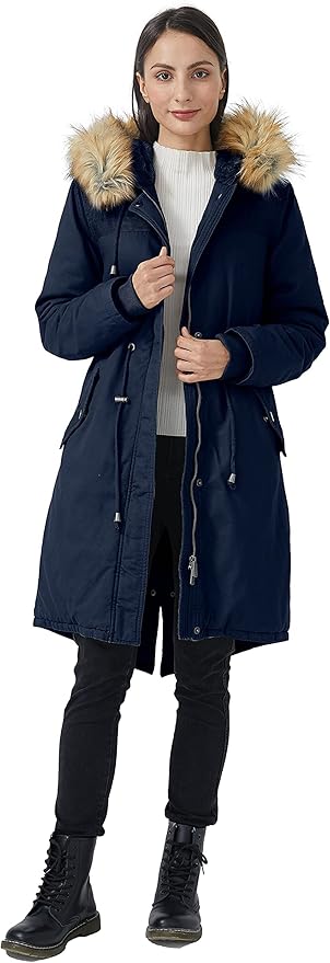 Person wearing a navy blue coat with a fur-lined hood on a white background