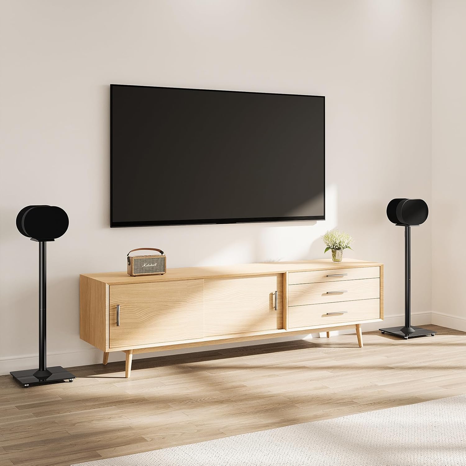 Wooden TV stand with a mounted television, speakers, and decorative items in a room.