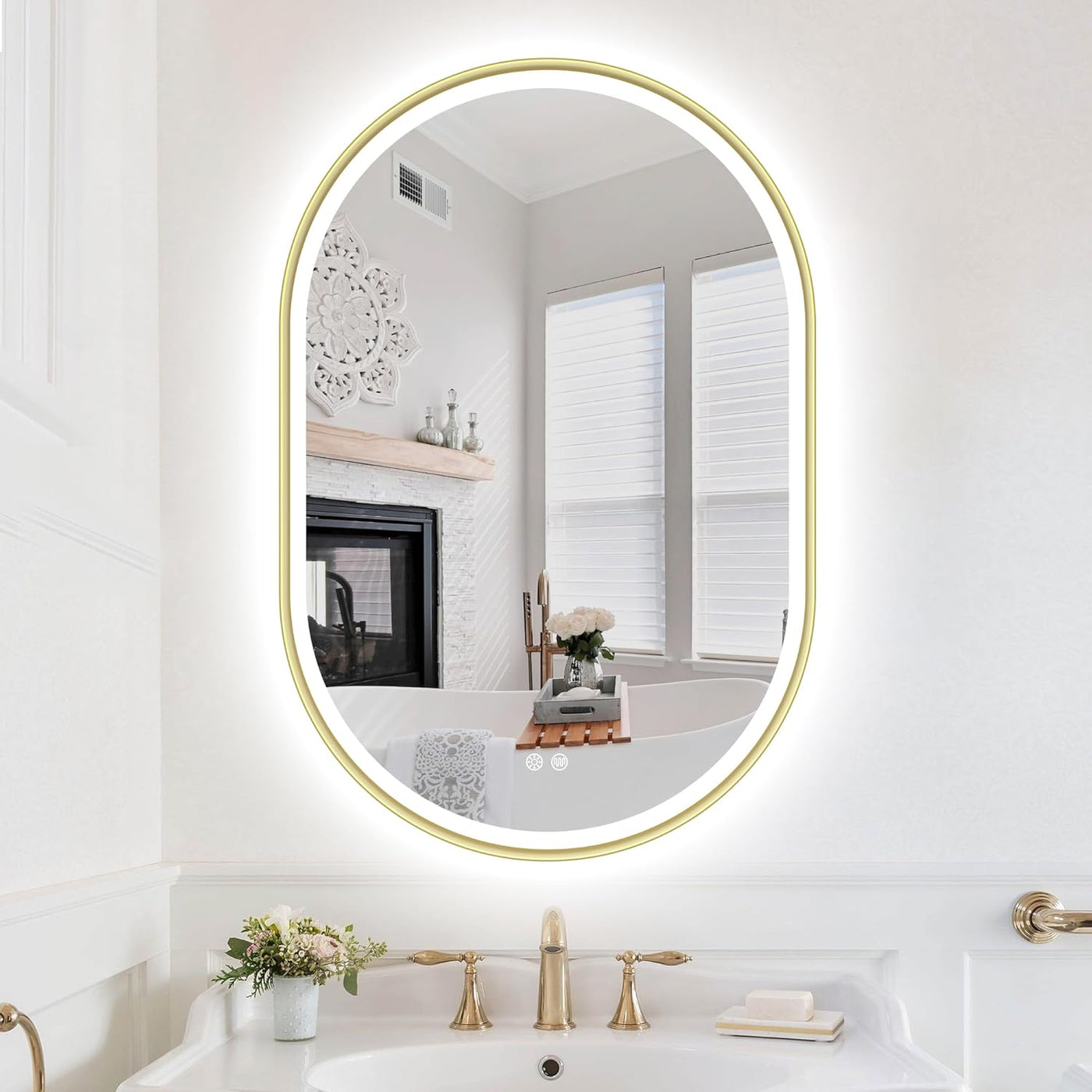 Bathroom with a round mirror with gold frame, sink, and decorative elements.
