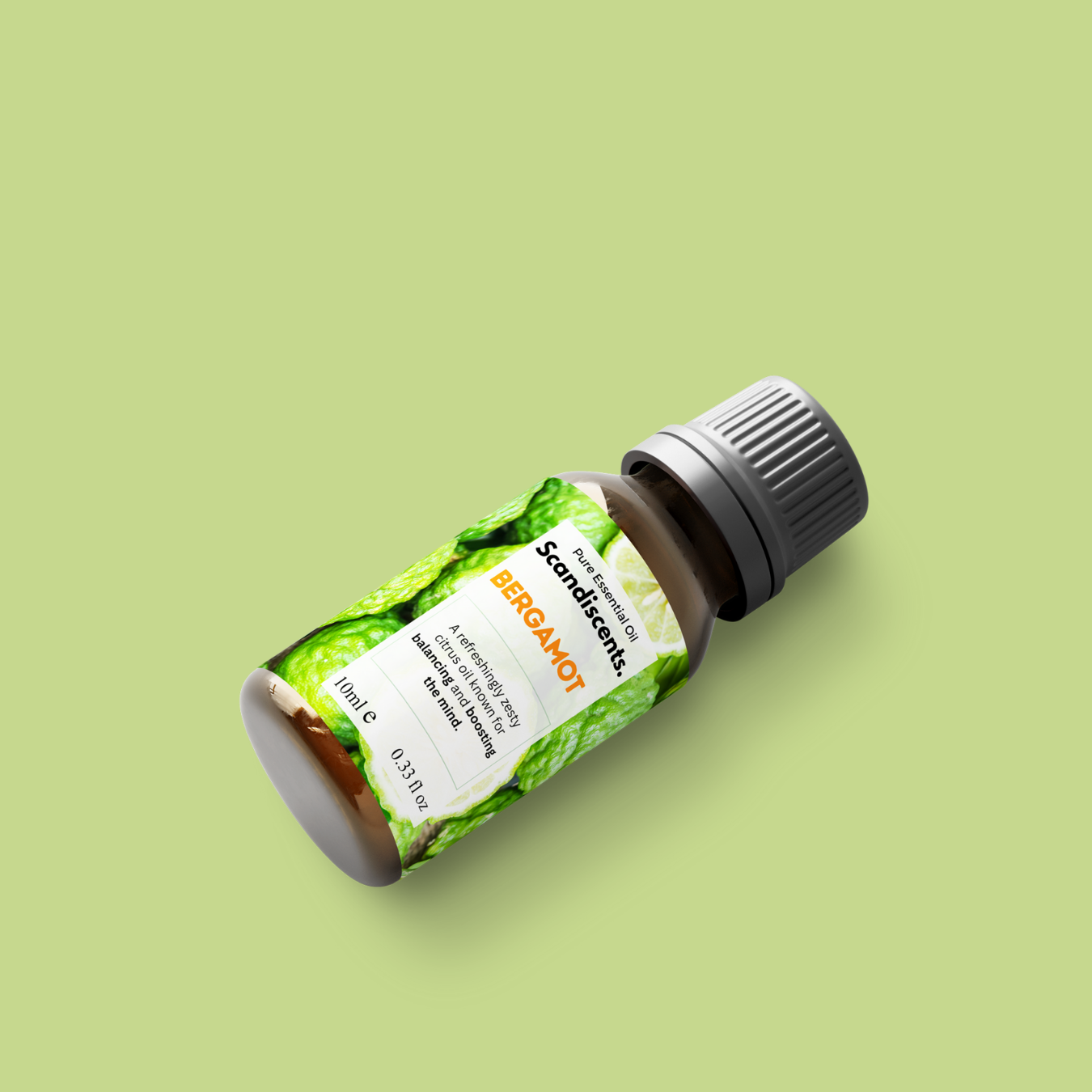Bottle of Bergamot essential oil with a green label on a light green background