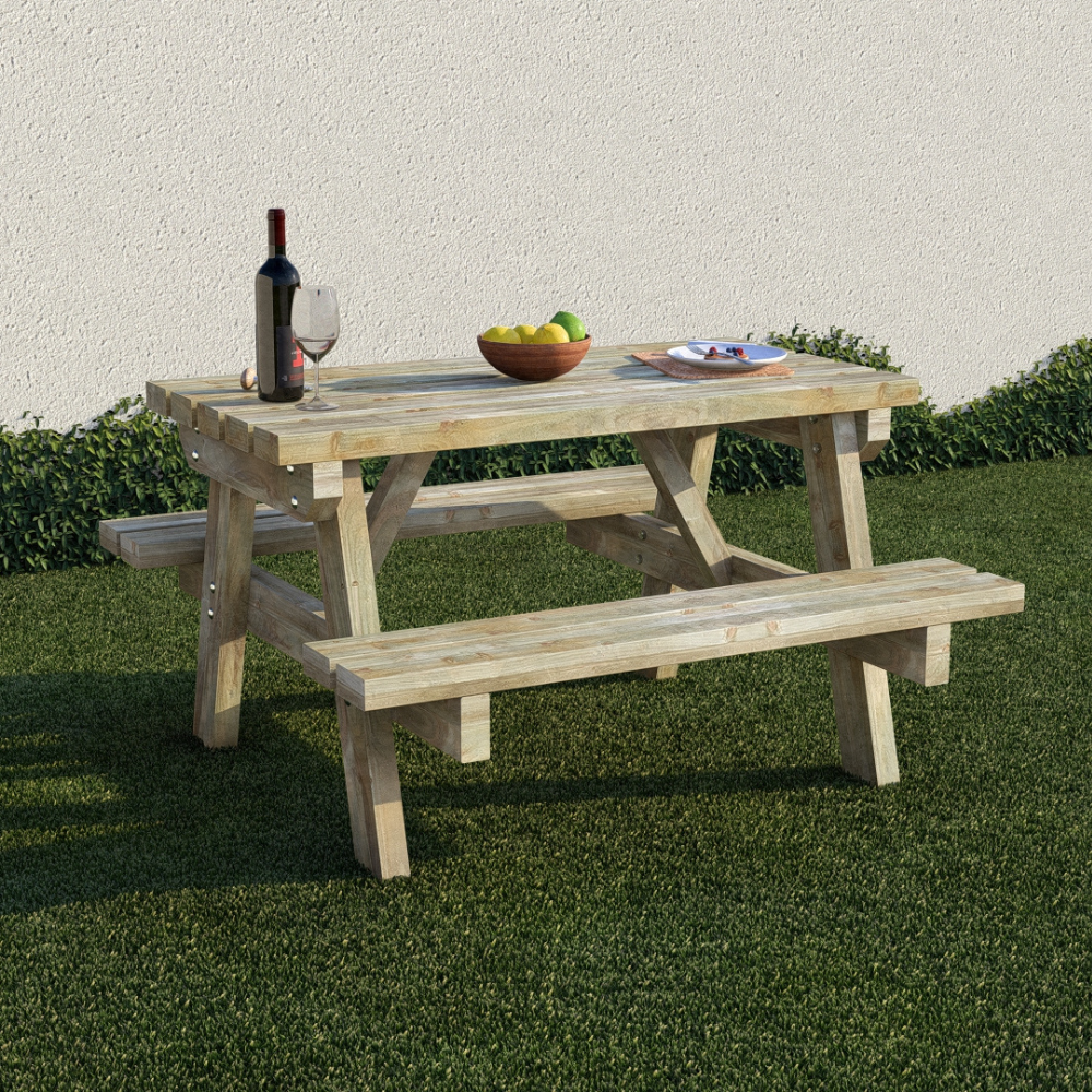 Wooden picnic table with a bottle of wine, glasses, and fruit on a grassy area.